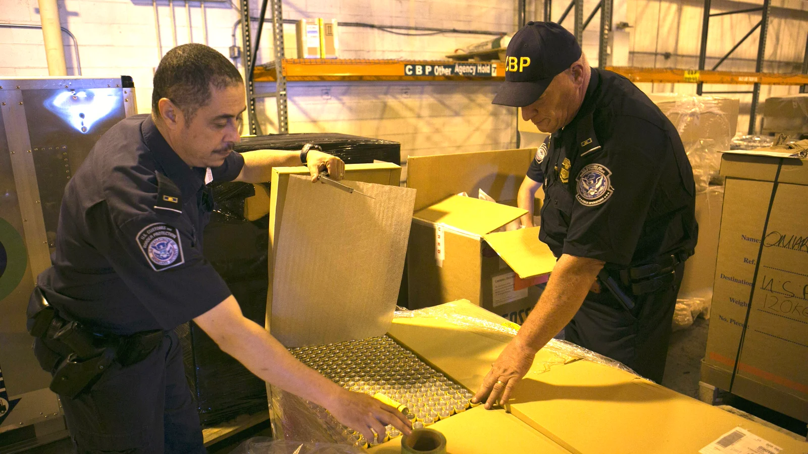 CBP officers opening cartons of imported goods for inspection at the Port of Philadelphia
