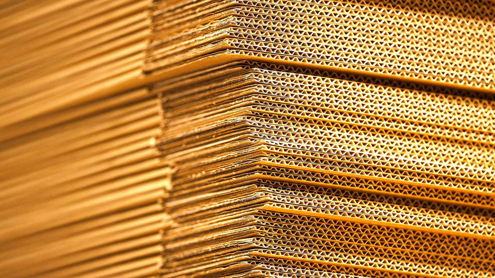Stack of flat corrugated cardboard boxes seen edge-on