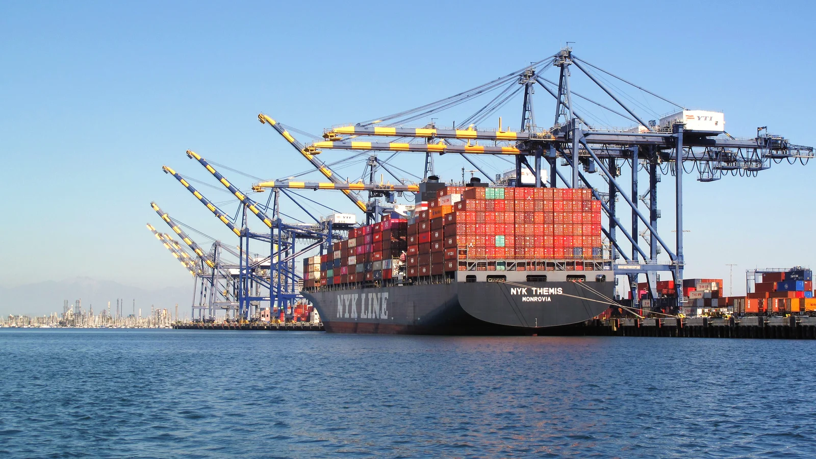 Container ship NYK Themis berthed under gantry cranes at the Port of Los Angeles