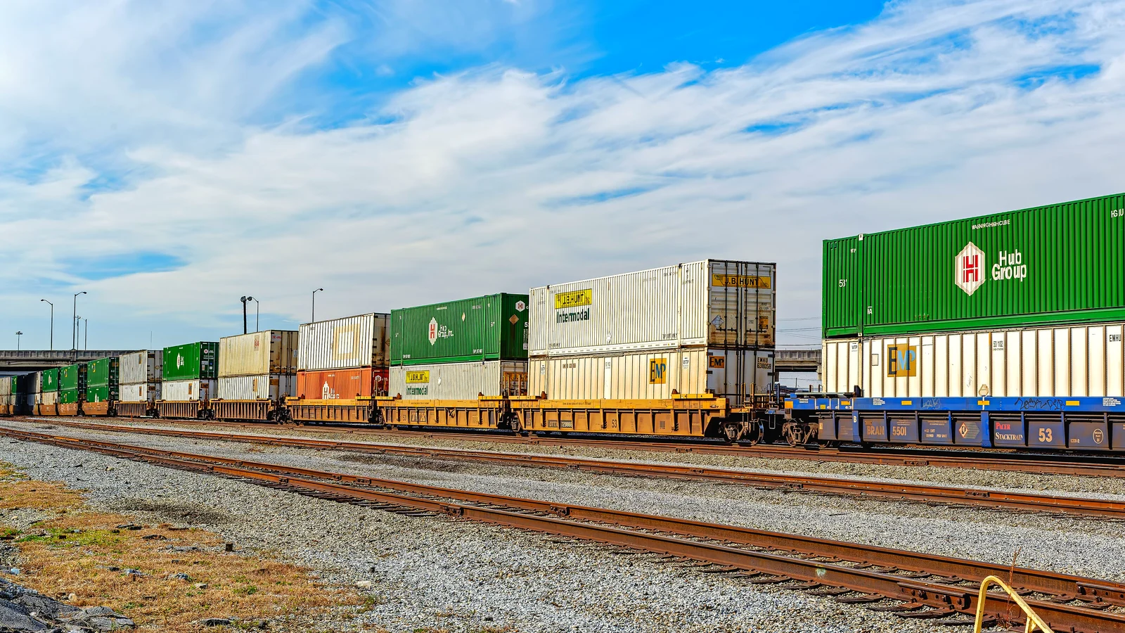 Intermodal freight train with double-stacked containers on flat cars near Knoxville, Tennessee