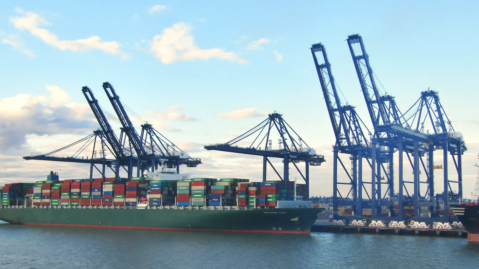 Container ship berthed beside blue gantry cranes at the Port of Felixstowe