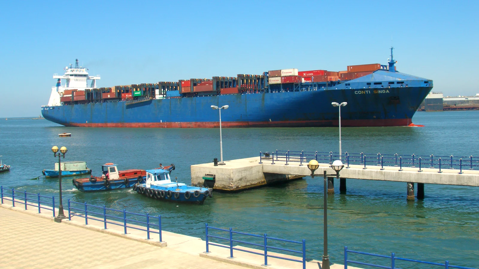 Container ship passing the waterfront at Port Said at the northern entrance of the Suez Canal